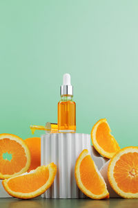 Close-up of orange bottle against blue background