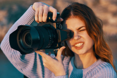 Portrait of woman photographing