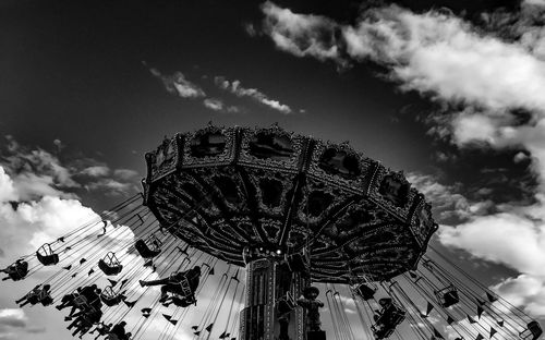 Low angle view of amusement park ride against sky