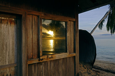 The window panes reflect the sunrise view