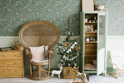 Cozy children room decorated for christmas with a decorated christmas tree and a wardrobe with toys