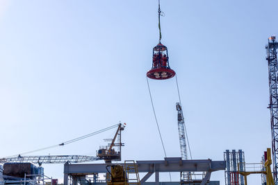 Low angle view of crane against clear sky