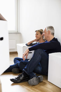 Mature couple relaxing after moving into their new house