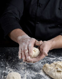 Midsection of chef preparing food