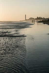 Scenic view of beach at sunset