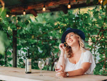 Portrait of a smiling young woman sitting outdoors