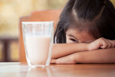 Portrait of girl with drink on table