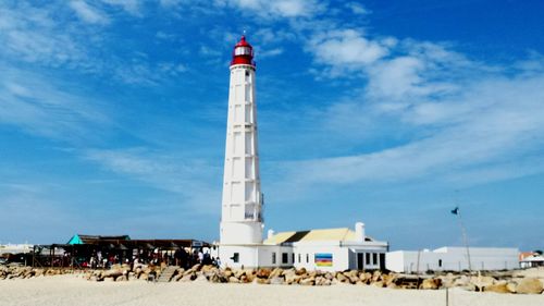 Lighthouse against cloudy sky