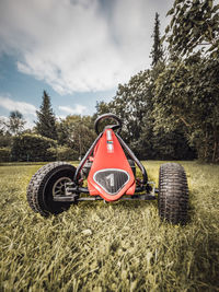 Vintage car on field against sky