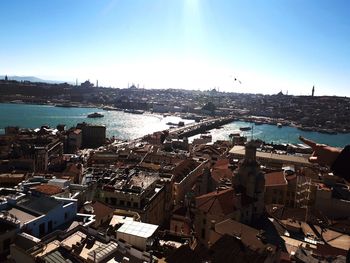 High angle view of townscape by sea against sky