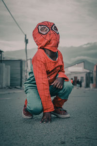 Full length of child on street in city against sky