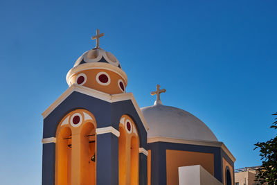 Low angle view of church against clear blue sky