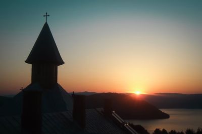 Silhouette building against sky during sunset