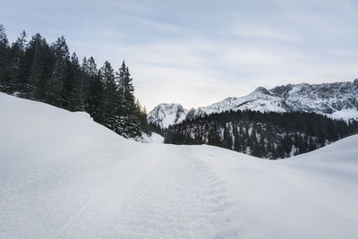 Scenic view of snow covered mountains against sky