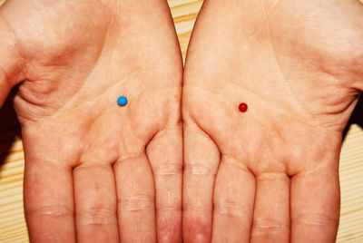 Close-up of men holding candies in cupped hands