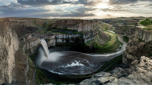 Scenic view of waterfall against sky