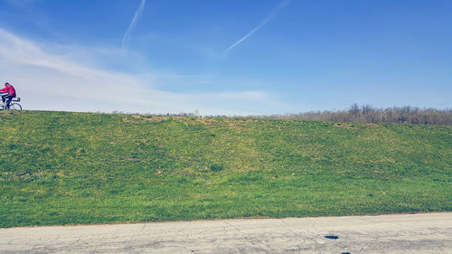 Scenic view of field against cloudy sky