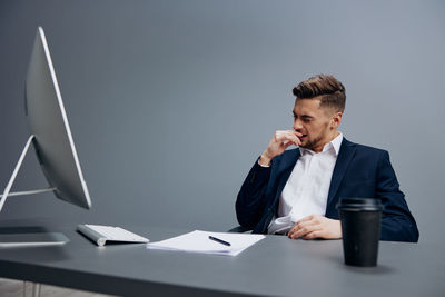 Portrait of businessman working at desk in office