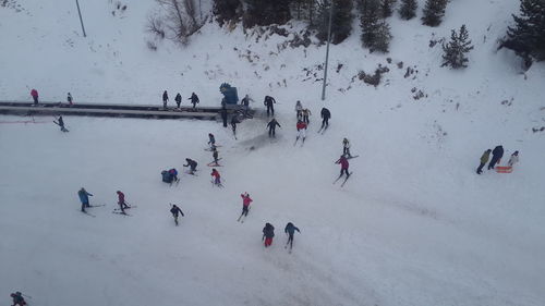 High angle view of people enjoying in snow