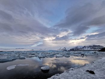 Scenic view of frozen sea against sky during winter