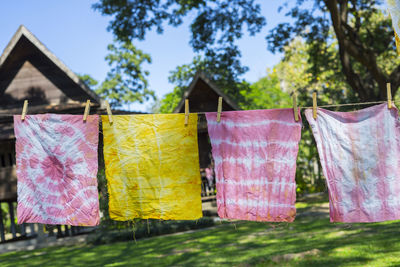 Close-up of clothes drying on clothesline against trees
