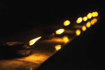 Close-up of lit candles in the dark
