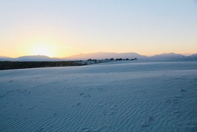 Scenic view of sea against clear sky during sunset