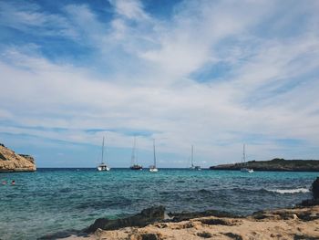 Sailboats on sea against sky