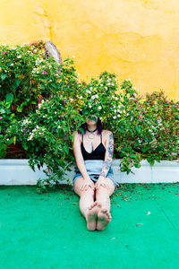 Thoughtful woman sitting alone outdoors. young worried in backyard