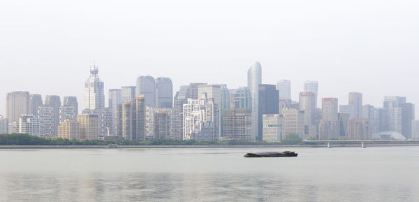 View of buildings in city against clear sky