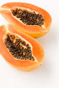 High angle view of orange fruit against white background