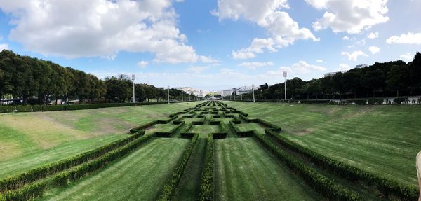 Panoramic view of agricultural field against sky