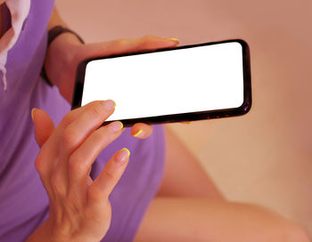 Midsection of woman holding smart phone