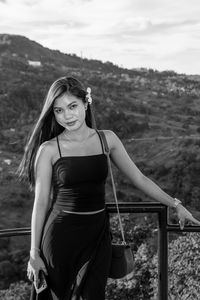 Portrait of beautiful woman standing on land