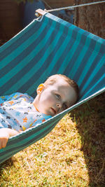 Portrait of boy lying on hammock