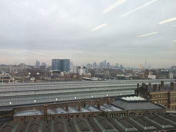 Cityscape against cloudy sky