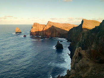 Scenic view of sea and rocks against sky