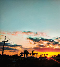 Silhouette buildings against sky during sunset