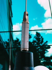 Low angle view of machine part against sky