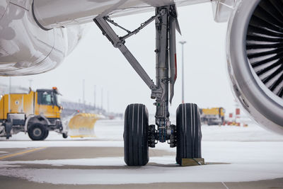 Winter day at airport during snowfall. selective focus on snowy airplane. 