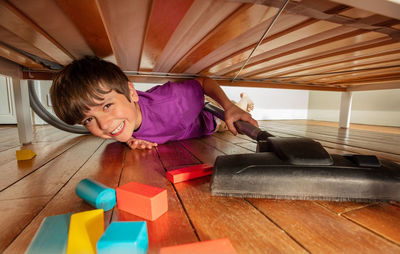 High angle view of boy playing with toy car