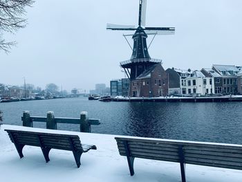 Commercial dock by river against buildings in city