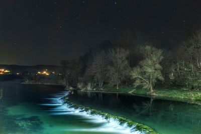 Scenic view of river against sky at night