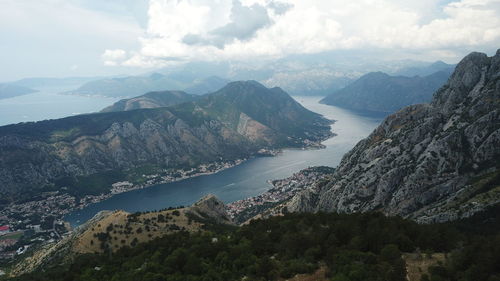 High angle view of lake and mountains against sky