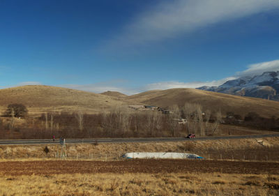 Scenic view of field against blue sky