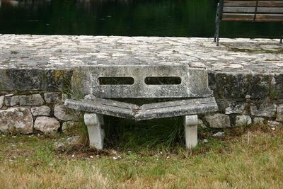 Information sign on grass by water