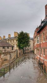 Street amidst buildings in city against sky