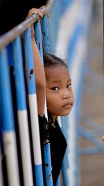 Portrait of girl hanging on railing