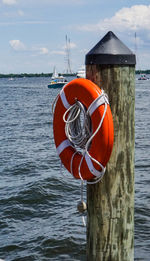 Red boat moored at sea against sky