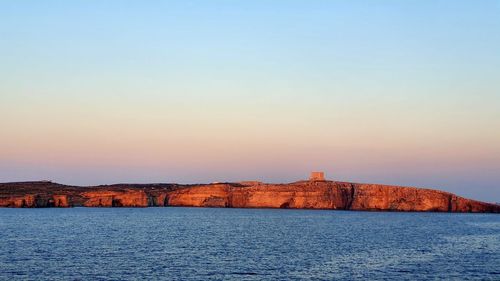 Scenic view of sea against clear sky during sunset